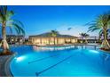 Community pool with a clubhouse and lush tropical landscaping at 3314 Chestertown Loop, Bradenton, FL 34211