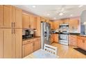 Bright kitchen featuring wood cabinets, stainless steel appliances, and granite countertops at 3443 Tallywood Cir # 7061, Sarasota, FL 34237