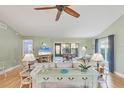 Cozy living room featuring a ceiling fan, comfortable seating, and sliding glass doors at 3443 Tallywood Cir # 7061, Sarasota, FL 34237