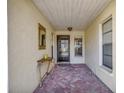 Inviting entryway with terracotta tile flooring and a decorative console table at 3709 Miguel Way # 8602, Sarasota, FL 34232