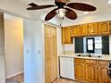 Kitchen boasts wood cabinets, a double sink, and built-in microwave at 4127 3Rd Ave W, Palmetto, FL 34221