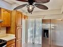 Kitchen features wood cabinets, stainless steel refrigerator, and access to patio at 4127 3Rd Ave W, Palmetto, FL 34221