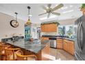 Island kitchen with granite countertops and stainless steel appliances at 4419 Mangrove Point Rd, Bradenton, FL 34210