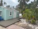 Charming teal cottage with a deck and tropical landscaping at 4510 Banan Pl, Sarasota, FL 34242