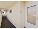 Condo hallway with light walls and a white door at 4775 Cove Cir # 202, St Petersburg, FL 33708