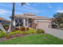 Single-story home with attached garage and lush landscaping at 531 Latitude Ln, Osprey, FL 34229