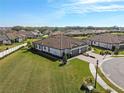 Single-story home with tile roof, two-car garage, and large backyard at 5439 Taliaferro Ct, Palmetto, FL 34221
