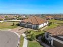 Single-story home with tile roof, two-car garage and grassy yard at 5439 Taliaferro Ct, Palmetto, FL 34221