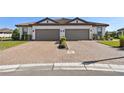Two-unit building with two-car garages and paver driveway at 5439 Taliaferro Ct, Palmetto, FL 34221