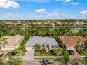 Single-Gathering house with a gray tile roof in a residential community with golf course views at 557 Marsh Creek Rd, Venice, FL 34292