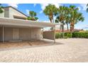 Covered parking area with pavers and tropical landscaping at 6202 Midnight Pass Rd # 201, Sarasota, FL 34242