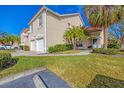 Two-story condo with two-car garage, landscaping, and walkway at 7133 Cedar Hollow Cir # 22-102, Bradenton, FL 34203