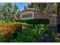 Stonehaven community sign surrounded by manicured landscaping and vibrant flowers at 7911 Moonstone Dr # 26-203, Sarasota, FL 34233