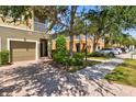 Charming townhome featuring a two-car garage, a private balcony, and mature landscaping at 7911 Moonstone Dr # 26-203, Sarasota, FL 34233