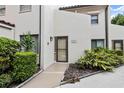 Condo building exterior, showing the entrance and landscaping at 800 Hudson Ave # 105, Sarasota, FL 34236