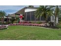 Landscaped yard with flowering plants and a single-story home at 8520 Imperial Cir, Palmetto, FL 34221