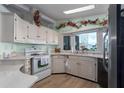 Bright kitchen featuring white cabinets and stainless steel appliances at 8520 Imperial Cir, Palmetto, FL 34221