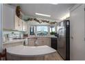 L-shaped kitchen with stainless steel appliances and corner sink at 8520 Imperial Cir, Palmetto, FL 34221