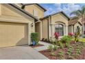 Lovely single-story home with manicured flower beds, a three-car garage, and a well-kept lawn at 9214 Raes Creek Pl, Palmetto, FL 34221