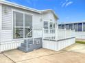 Mobile home's exterior showcasing a gray and white color scheme, steps leading to a deck at 3333 26Th E Ave # 1120, Bradenton, FL 34208