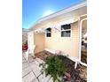 Side view of a yellow home showcasing a shed and a partially visible patio area at 108 1St Ave, Venice, FL 34285