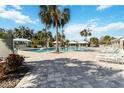 Community pool with lounge chairs and shaded seating areas at 10931 Blue Magnolia Ln, Parrish, FL 34219