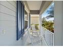 Relaxing front porch with rocking chairs and white railings at 10931 Blue Magnolia Ln, Parrish, FL 34219