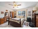 Comfortable bedroom with a large window, ceiling fan, and a charming wood-framed bed at 1119 76Th Nw St, Bradenton, FL 34209