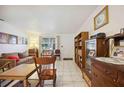 Living room with tiled floors, rocking chairs, and built-in shelving at 1119 76Th Nw St, Bradenton, FL 34209