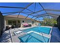 Large, screened-in pool with spacious spa and plenty of lounging space at 11924 Forest Park Cir, Lakewood Ranch, FL 34211