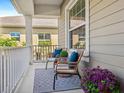 Relaxing front porch with wicker chairs and a patterned rug at 12310 Halfmoon Lake Ter, Bradenton, FL 34211