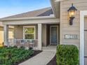 Inviting front porch with white railing, seating, and landscaping at 12310 Halfmoon Lake Ter, Bradenton, FL 34211