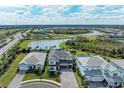 Community overview with lake and houses at 16446 Slate Pl, Bradenton, FL 34211