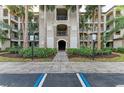 Condo building entrance with lush landscaping and parking at 16706 Vardon Ter # 205, Bradenton, FL 34211