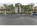 Condo building with palm trees and covered parking at 16904 Vardon Ter # 405, Bradenton, FL 34211