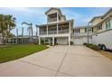 Two-story house with balcony, two-car garage, and driveway at 220 82Nd St, Holmes Beach, FL 34217