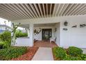 Inviting front porch with brick flooring and a covered entryway at 220 82Nd St, Holmes Beach, FL 34217