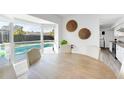 Bright dining room with large window overlooking pool at 2743 Fountain Pl, Sarasota, FL 34235