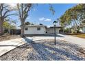 House exterior showcasing front yard landscaping and driveway at 2743 Fountain Pl, Sarasota, FL 34235