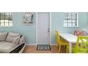 Bright dining area with white table and colorful chairs at 3200 Tobero Ln, Sarasota, FL 34235