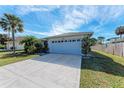 Front view of single-story house with garage and yard at 4410 70Th E Dr, Sarasota, FL 34243