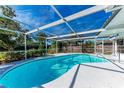 Relaxing screened-in pool with clear blue water and plenty of space for outdoor lounging at 4410 70Th E Dr, Sarasota, FL 34243