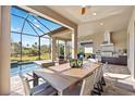 Outdoor kitchen with dining area and pool view at 5255 Cicerone St, Sarasota, FL 34238