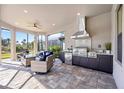 Outdoor kitchen with stainless steel appliances and seating at 5255 Cicerone St, Sarasota, FL 34238