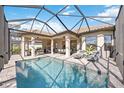 Resort-style pool with covered lanai and lounge chairs at 5255 Cicerone St, Sarasota, FL 34238