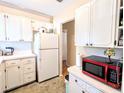 Functional kitchen featuring white cabinets, modern appliances, and ample counter space at 5918 Palm Ln # C33, Bradenton, FL 34207