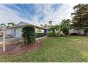 House exterior with landscaping and a walkway at 6009 Bonaventure Pl, Sarasota, FL 34243