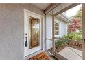 White front door with glass panels and welcome mat at 6009 Bonaventure Pl, Sarasota, FL 34243