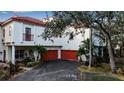 Beautiful white-painted villa exterior with a red roof and attached two-car garages at 6442 Mourning Dove Dr # 6442, Bradenton, FL 34210