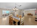 Dining room features a large table and access to the kitchen at 6824 Jarvis Rd, Sarasota, FL 34241